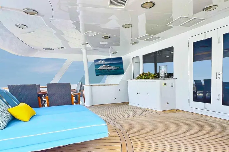 Slide: The Image of Luxurious 2003 Trinity Yachts motoryacht deck with seating, TV, and ocean view. - 28