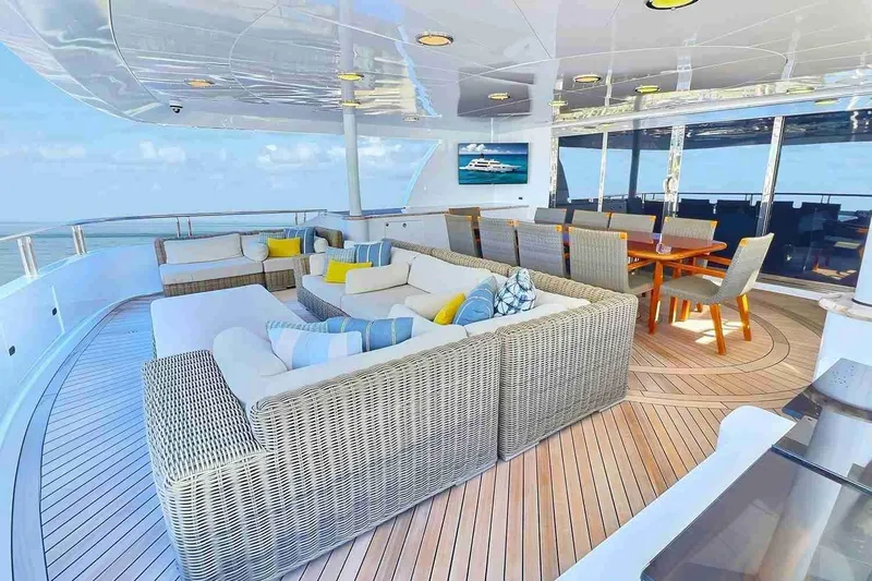 Slide: The Image of Luxurious 2003 Trinity Yachts motoryacht deck with elegant seating and dining area. - 30