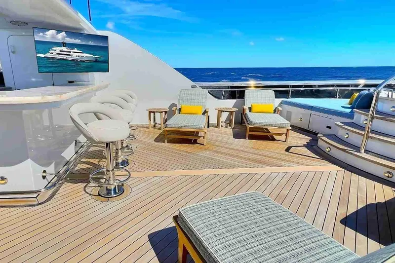 Slide: The Image of Luxurious 2003 Trinity Yachts motoryacht deck with bar, lounge chairs, and ocean view. - 33