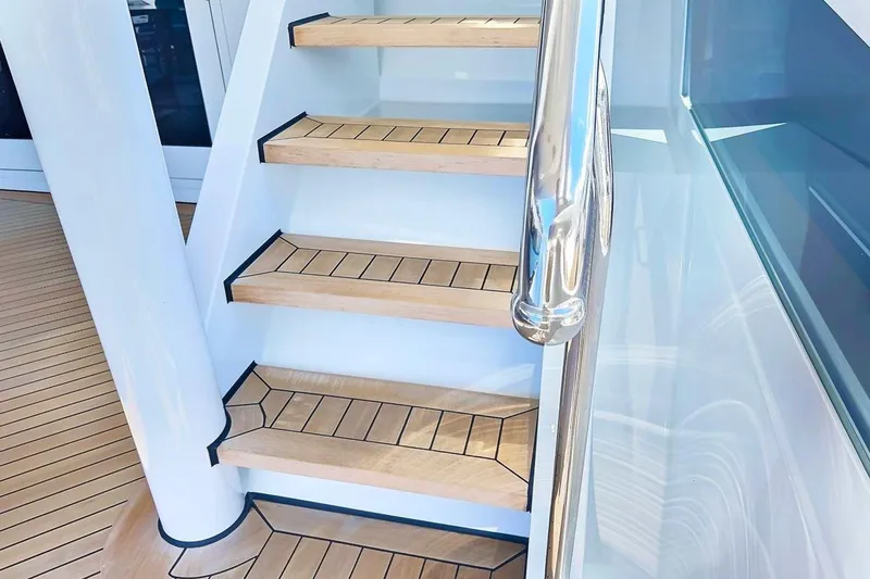 Slide: The Image of Staircase on 2003 Trinity Yachts Motoryacht with wooden steps and sleek railing. - 36