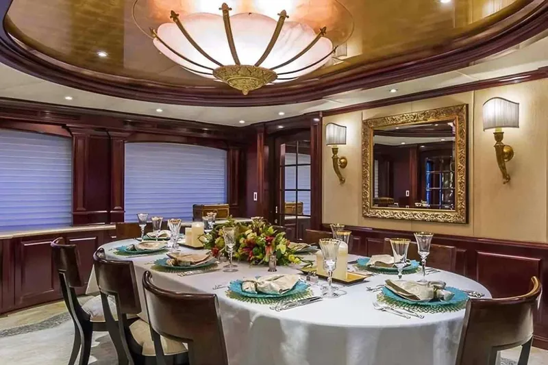 Slide: The Image of Luxurious dining area on a 2003 Trinity Yachts motoryacht, featuring elegant decor and table setting. - 9