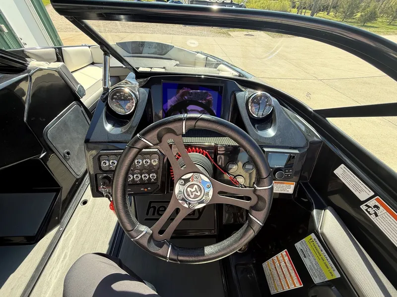 Slide: The Image of Interior view of 2023 Heyday WTSurf boat cockpit with steering wheel and instruments. - 17