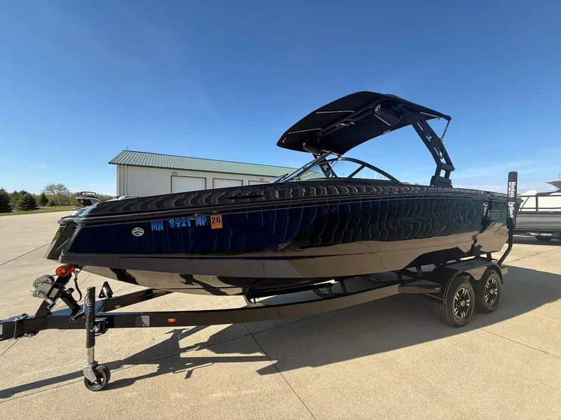 Slide: The Image of 2023 Heyday WTSurf boat on trailer, blue sky. - 2
