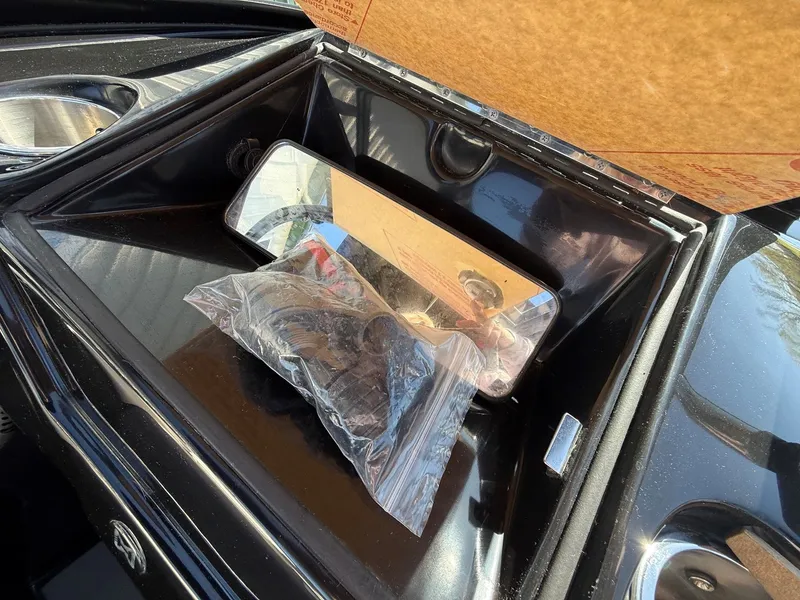 Slide: The Image of Heyday WTSurf 2023 boat mirror and accessories in storage compartment. - 21