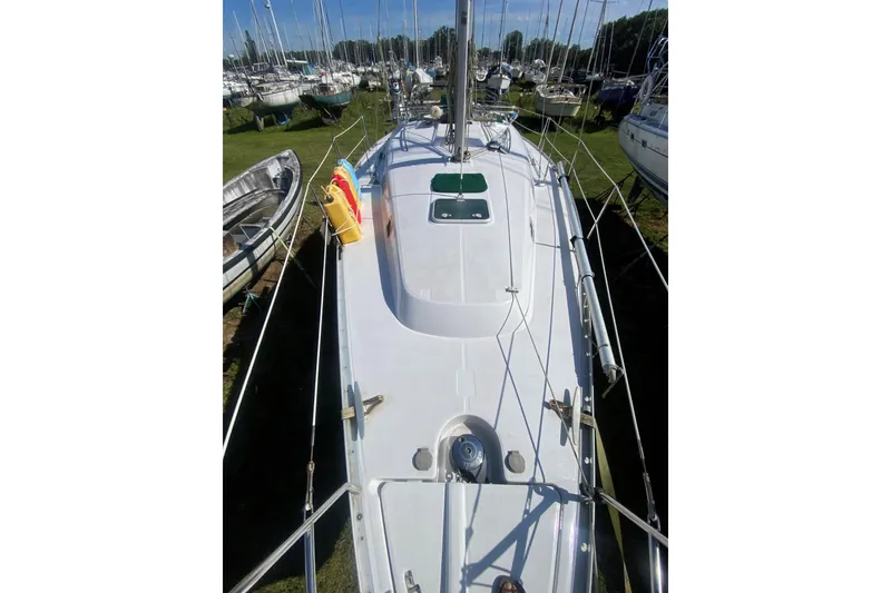 Slide: The Image of 2002 Beneteau Oceanis Clipper 361 sailboat on land, surrounded by other boats. - 1