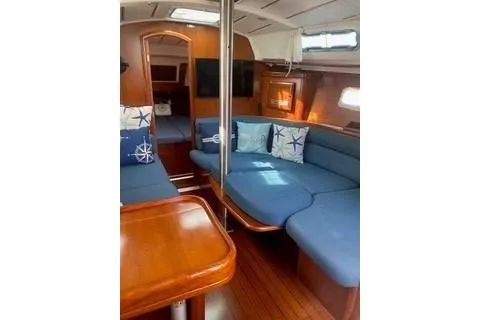 Slide: The Image of Interior of 2002 Beneteau Oceanis Clipper 361 yacht with blue seating and wooden finishes. - 14