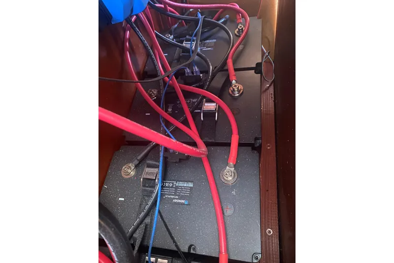 Slide: The Image of Battery compartment of a 2002 Beneteau Oceanis Clipper 361 sailboat with red and black cables. - 19
