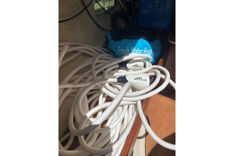 Slide: The Image of Coiled white hoses and blue bag on 2002 Beneteau Oceanis Clipper 361 sailboat. - 28
