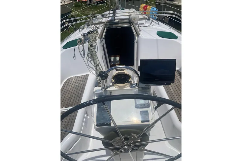 Slide: The Image of 2002 Beneteau Oceanis Clipper 361 cockpit with steering wheel and navigation equipment. - 30