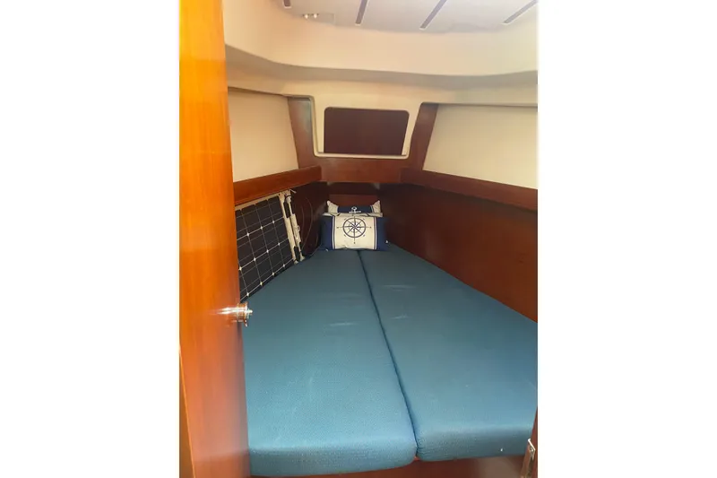 Slide: The Image of Cozy cabin interior of 2002 Beneteau Oceanis Clipper 361 sailboat with blue cushions. - 9