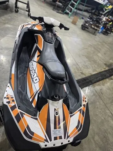 Slide: The Image of 2017 Sea-Doo SPARK™ jet ski in workshop, orange-black-white design. - 7
