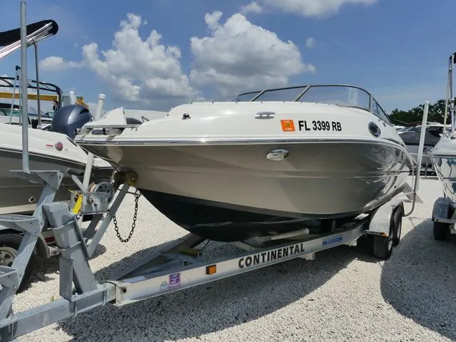 The Image of 2016 Stingray 214 LR boat on trailer under blue sky. - 1