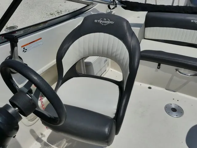 Slide: The Image of Interior of a 2016 Stingray 214 LR boat with steering wheel and seat. - 10