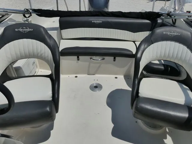 Slide: The Image of Interior of a 2016 Stingray 214 LR boat with black and white seating. - 12