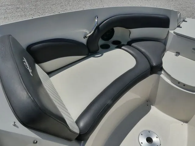 Slide: The Image of Interior of a 2016 Stingray 214 LR boat with cushioned seating. - 15