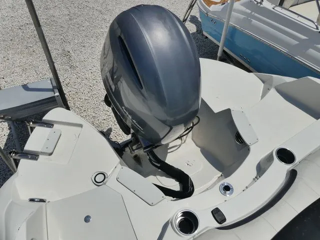 Slide: The Image of 2016 Stingray 214 LR boat with outboard motor on gravel. - 5