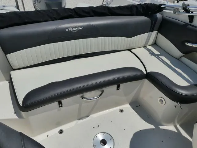 Slide: The Image of Interior of a 2016 Stingray 214 LR boat with black and white upholstery. - 6