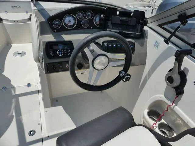 Slide: The Image of Interior view of a 2016 Stingray 214 LR boat cockpit. - 8