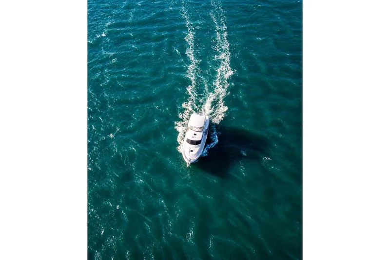 Slide: The Image of Aerial view of 2005 Symbol 58 Pilothouse yacht cruising on blue ocean waters. - 10