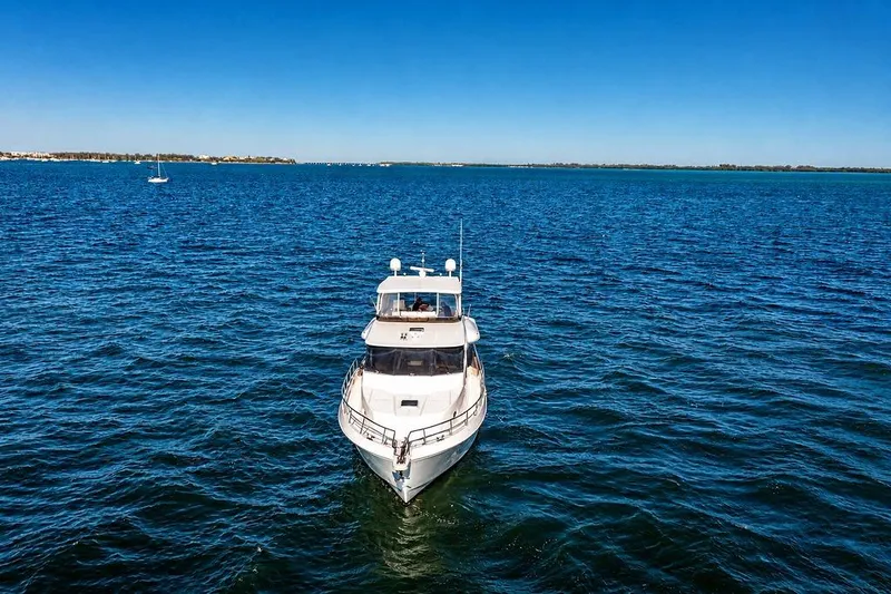 Slide: The Image of 2005 Symbol 58 Pilothouse yacht cruising on open blue water. - 11