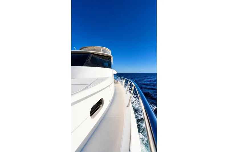 Slide: The Image of 2005 Symbol 58 Pilothouse yacht cruising on open sea under clear blue sky. - 12