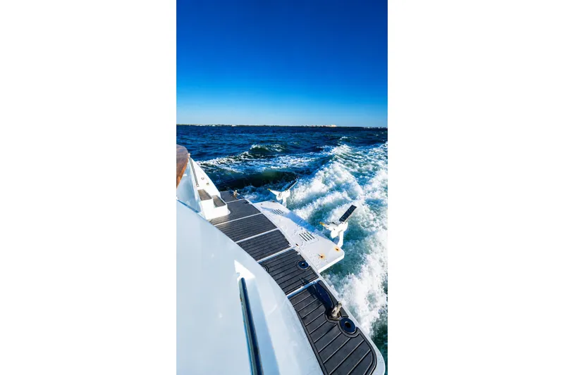 Slide: The Image of Symbol 58 Pilothouse yacht cruising on open sea, 2005 model, with clear blue skies. - 13