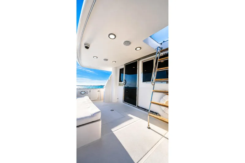 Slide: The Image of 2005 Symbol 58 Pilothouse yacht deck with seating, ladder, and ocean view. - 14