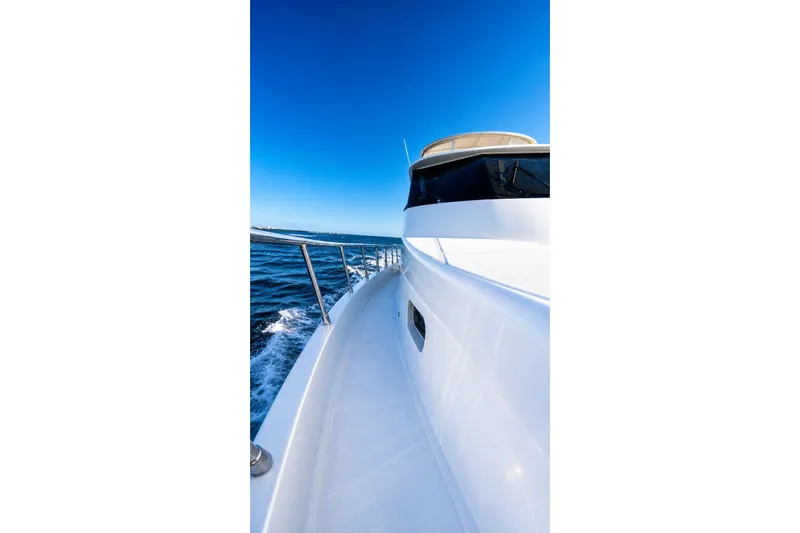 Slide: The Image of 2005 Symbol 58 Pilothouse yacht cruising on open water under clear blue sky. - 18