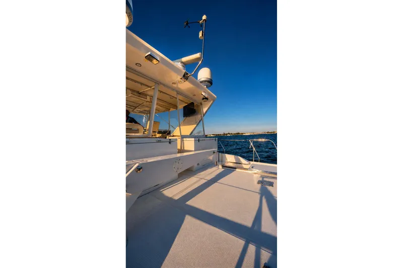 Slide: The Image of 2005 Symbol 58 Pilothouse yacht deck with clear blue sky and ocean view. - 19