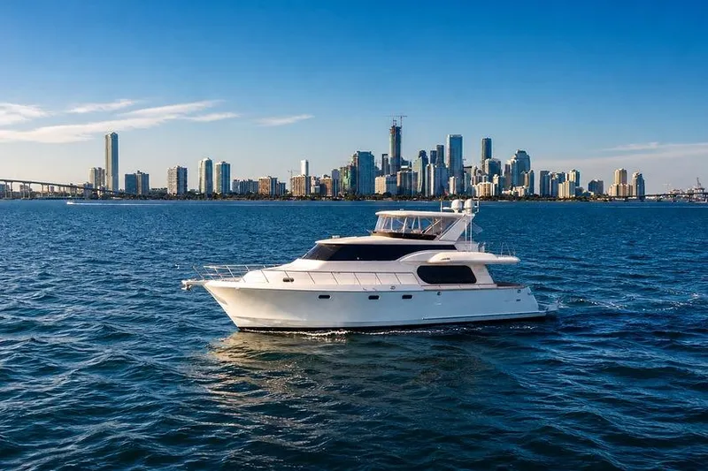 Slide: The Image of Luxury yacht Symbol 58 Pilothouse 2005 cruising near city skyline on a sunny day. - 2