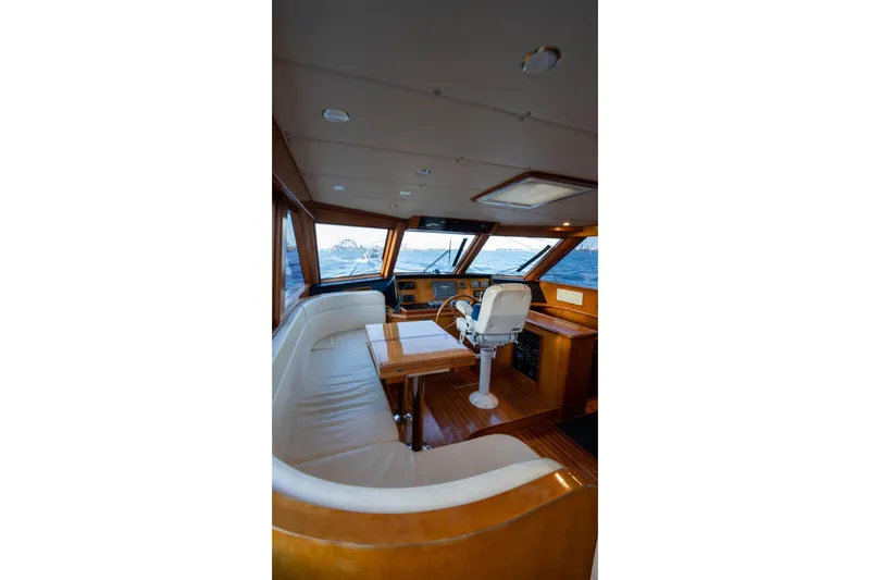 Slide: The Image of Luxurious interior of 2005 Symbol 58 Pilothouse yacht with helm and seating area. - 20