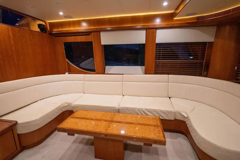 Slide: The Image of Luxurious interior of 2005 Symbol 58 Pilothouse yacht with elegant seating and wooden accents. - 25