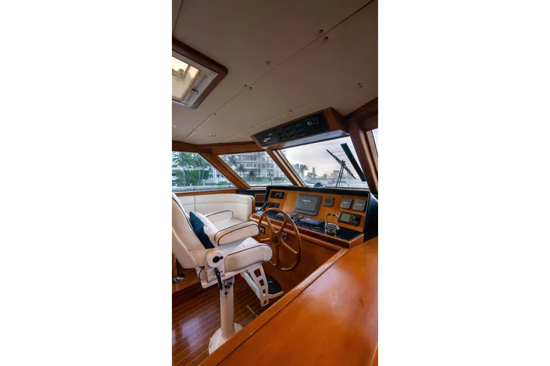 Slide: The Image of Pilothouse interior of 2005 Symbol 58, featuring helm station and luxurious seating. - 28