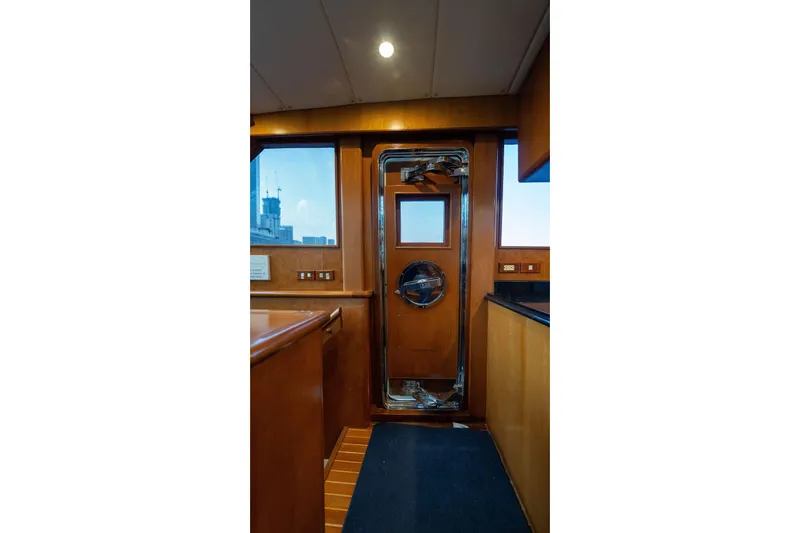 Slide: The Image of Interior view of 2005 Symbol 58 Pilothouse yacht with wooden door and windows. - 29