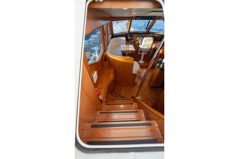 Slide: The Image of Interior view of 2005 Symbol 58 Pilothouse yacht with wooden stairs and helm. - 31