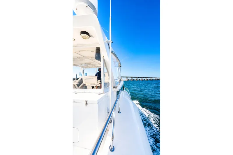 Slide: The Image of 2005 Symbol 58 Pilothouse yacht cruising on open water under clear blue sky. - 41