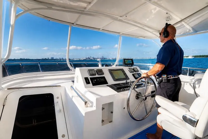 Slide: The Image of Person steering 2005 Symbol 58 Pilothouse yacht on open water. - 45