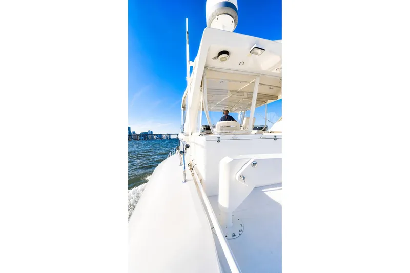 Slide: The Image of 2005 Symbol 58 Pilothouse yacht cruising on open water under clear blue sky. - 47