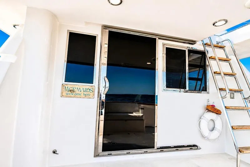 Slide: The Image of 2005 Symbol 58 Pilothouse yacht with sliding glass door and ladder. - 49