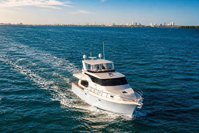 Slide: The Image of Luxury 2005 Symbol 58 Pilothouse yacht cruising on open blue waters. - 5