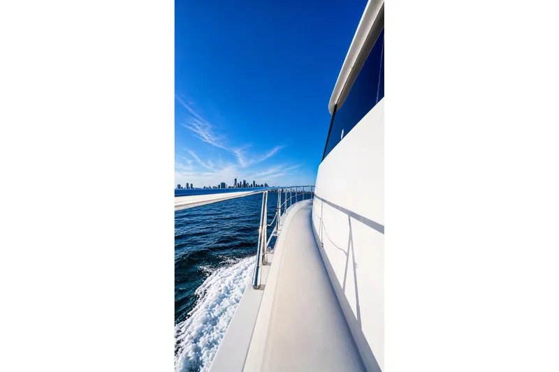 Slide: The Image of Side view of 2005 Symbol 58 Pilothouse yacht cruising on open water. - 50