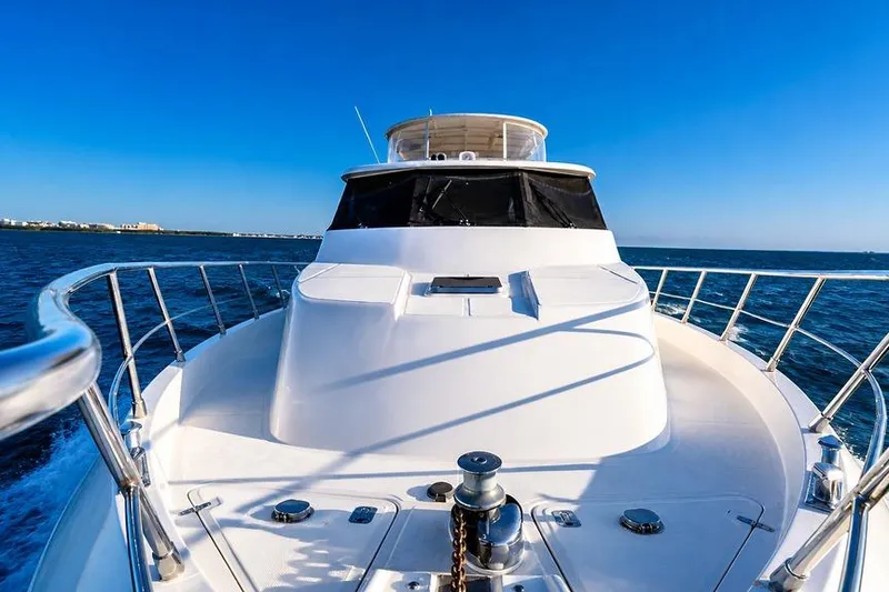 Slide: The Image of Front view of a 2005 Symbol 58 Pilothouse yacht cruising on open water. - 51