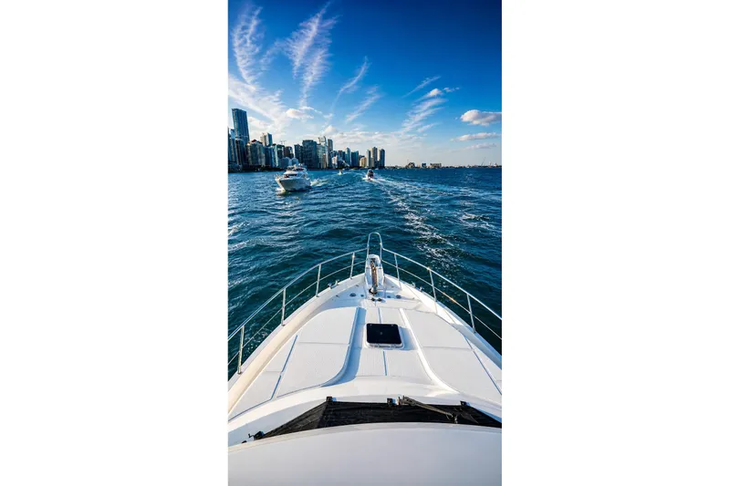 Slide: The Image of Bow view of 2005 Symbol 58 Pilothouse yacht cruising towards city skyline. - 52