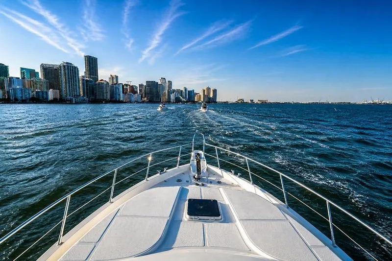 Slide: The Image of Bow view of 2005 Symbol 58 Pilothouse yacht cruising near city skyline. - 53