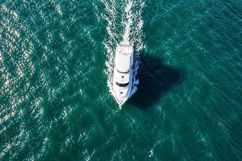 Slide: The Image of Aerial view of 2005 Symbol 58 Pilothouse yacht cruising on blue ocean waters. - 7