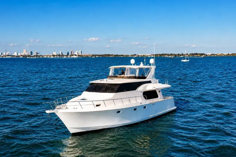 Slide: The Image of 2005 Symbol 58 Pilothouse yacht cruising on blue ocean near city skyline. - 8