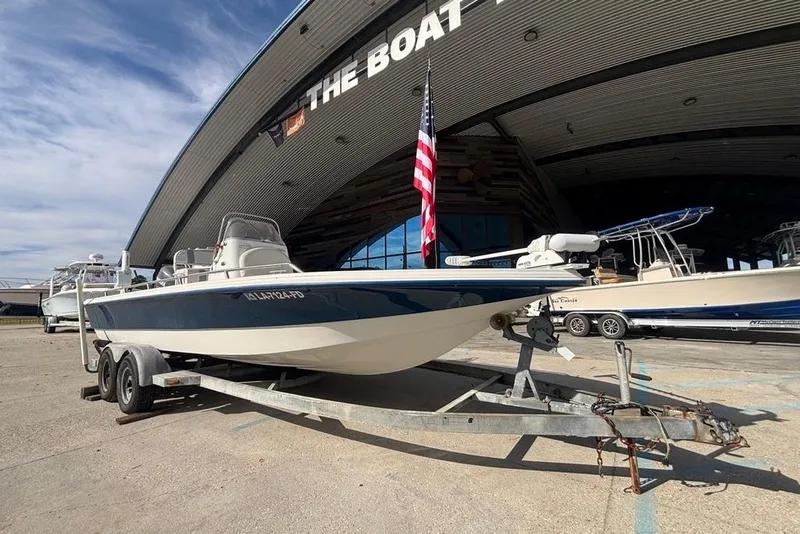 Slide: The Image of 2001 Bay Stealth 2230 boat on trailer outside a large boat dealership. - 7