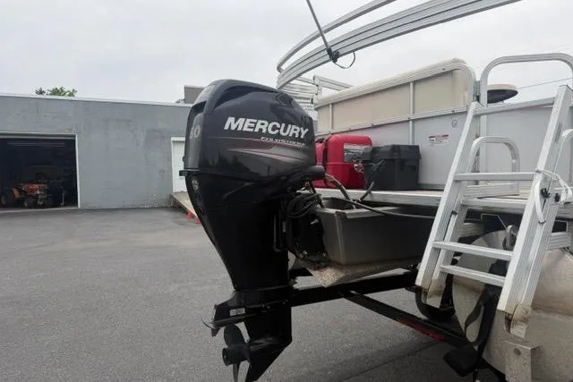 Slide: The Image of 2016 SunChaser Oasis Fish 820 Cruise-N-Fish with Mercury outboard motor in a parking area. - 2