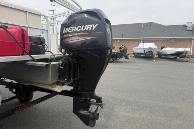 Slide: The Image of 2016 SunChaser Oasis Fish 820 Cruise-N-Fish with Mercury outboard motor in parking lot. - 3