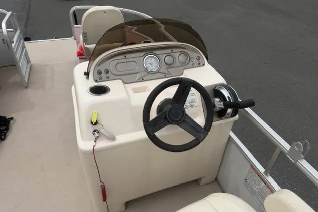 Slide: The Image of 2016 SunChaser Oasis Fish 820 Cruise-N-Fish boat dashboard with steering wheel and controls. - 7